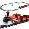 THE TWIDDLERS 15 Pièces Train de Noël Électrique avec Rails, Lumières, Sons & Accessoires - avec Boîte-Cadeau - Déco de Table